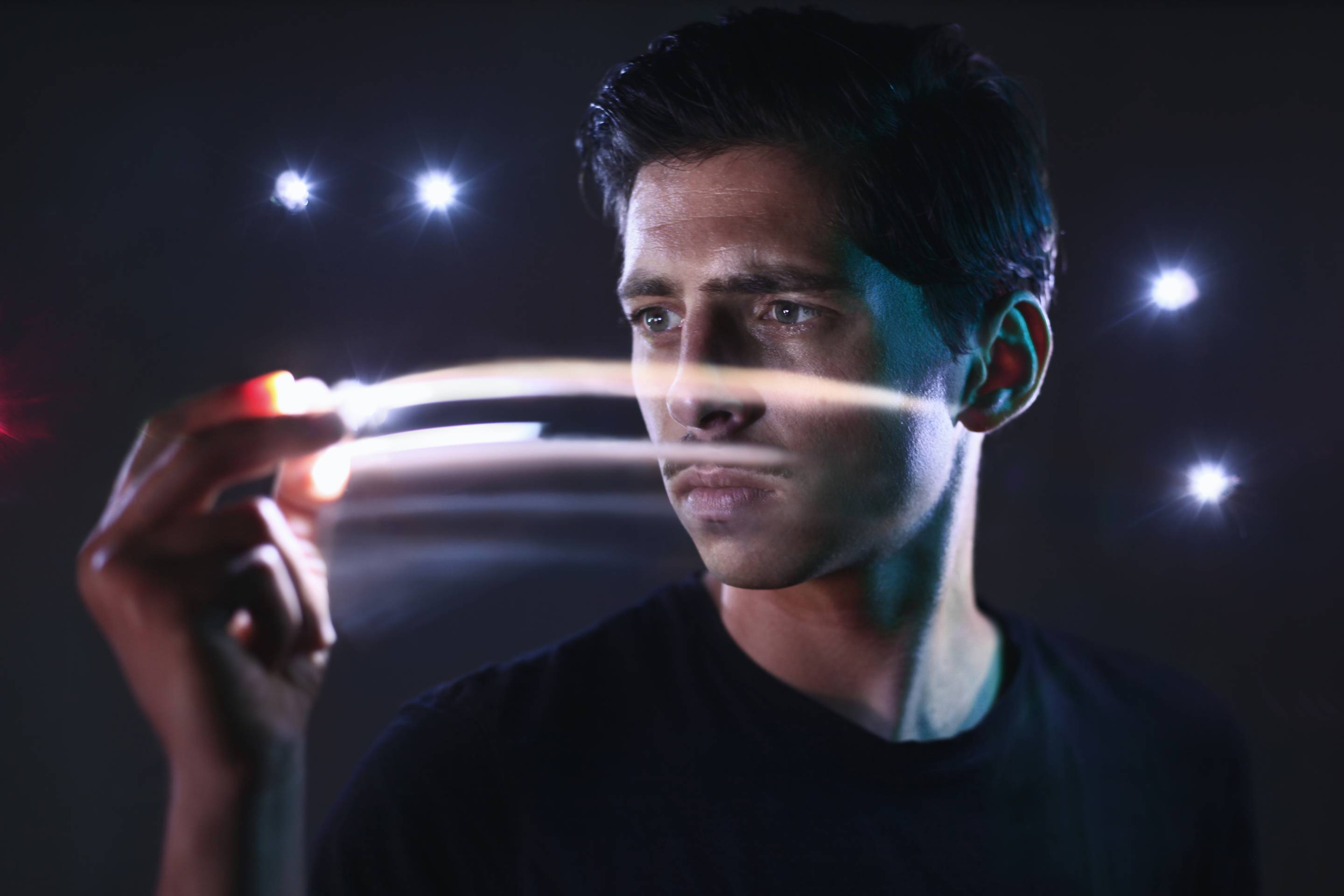 Portrait of man moving lights in his hand