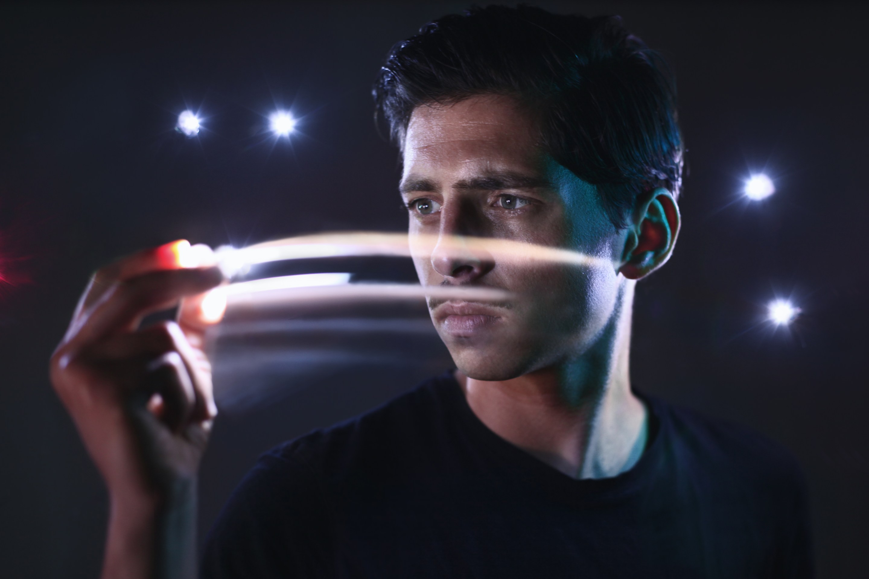 Portrait of man moving lights in his hand