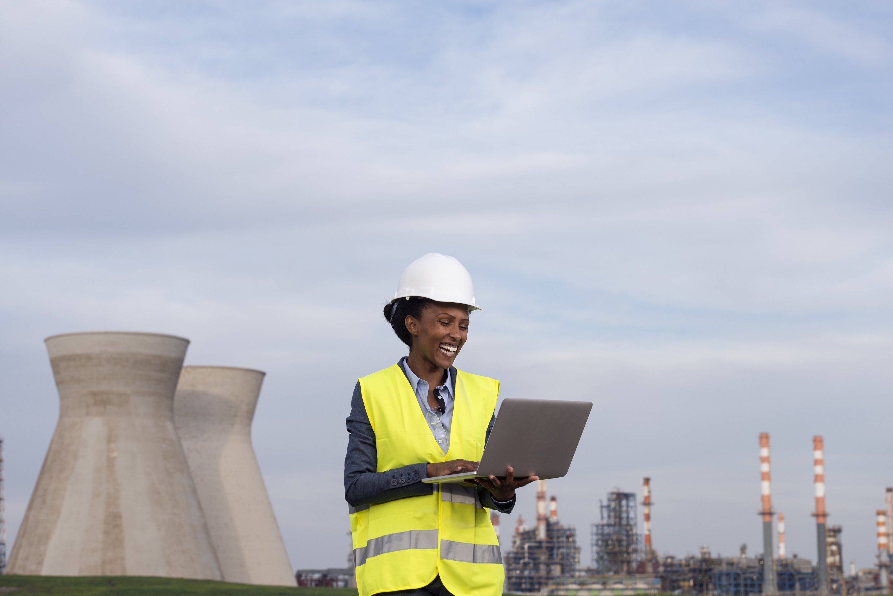 Woman engineer checking the data of oil refinery.